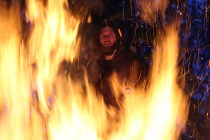 Vincent Weaver, framed in the flames of a bonefire at Duck Lake in Yellowknife, NWT.
